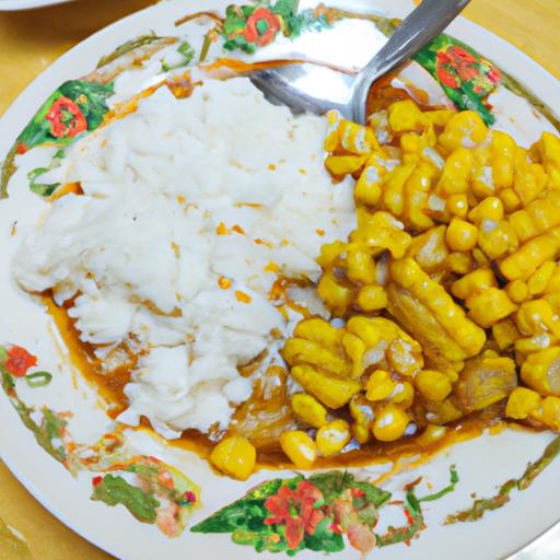 Một đĩa bắp Mỹ xào thơm ngon được trình bày cùng cơm trắng và món ăn kèm.